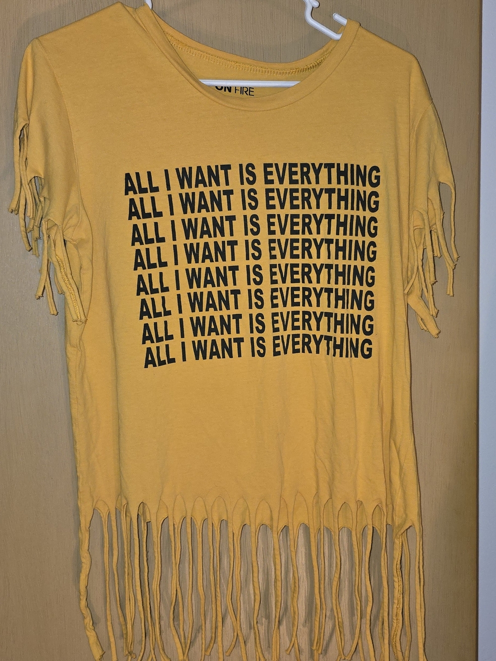 On Fire Yellow Fringe Tee with Repeated 'All I Want Is Everything' Graphic